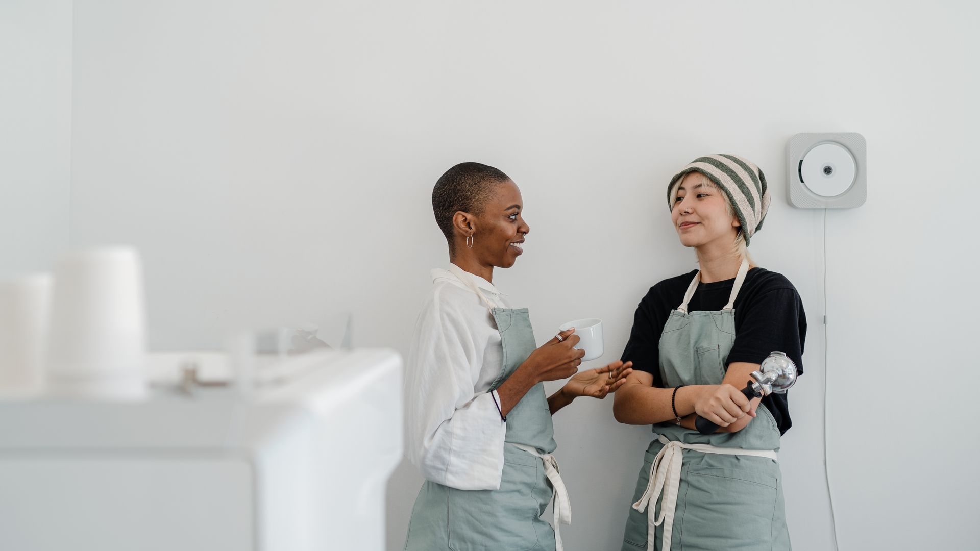 Two baristas working calmly behind the counter