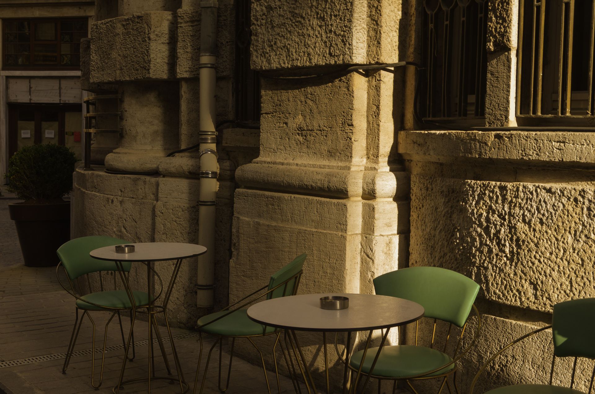 Outdoor café tables and chairs in golden evening light