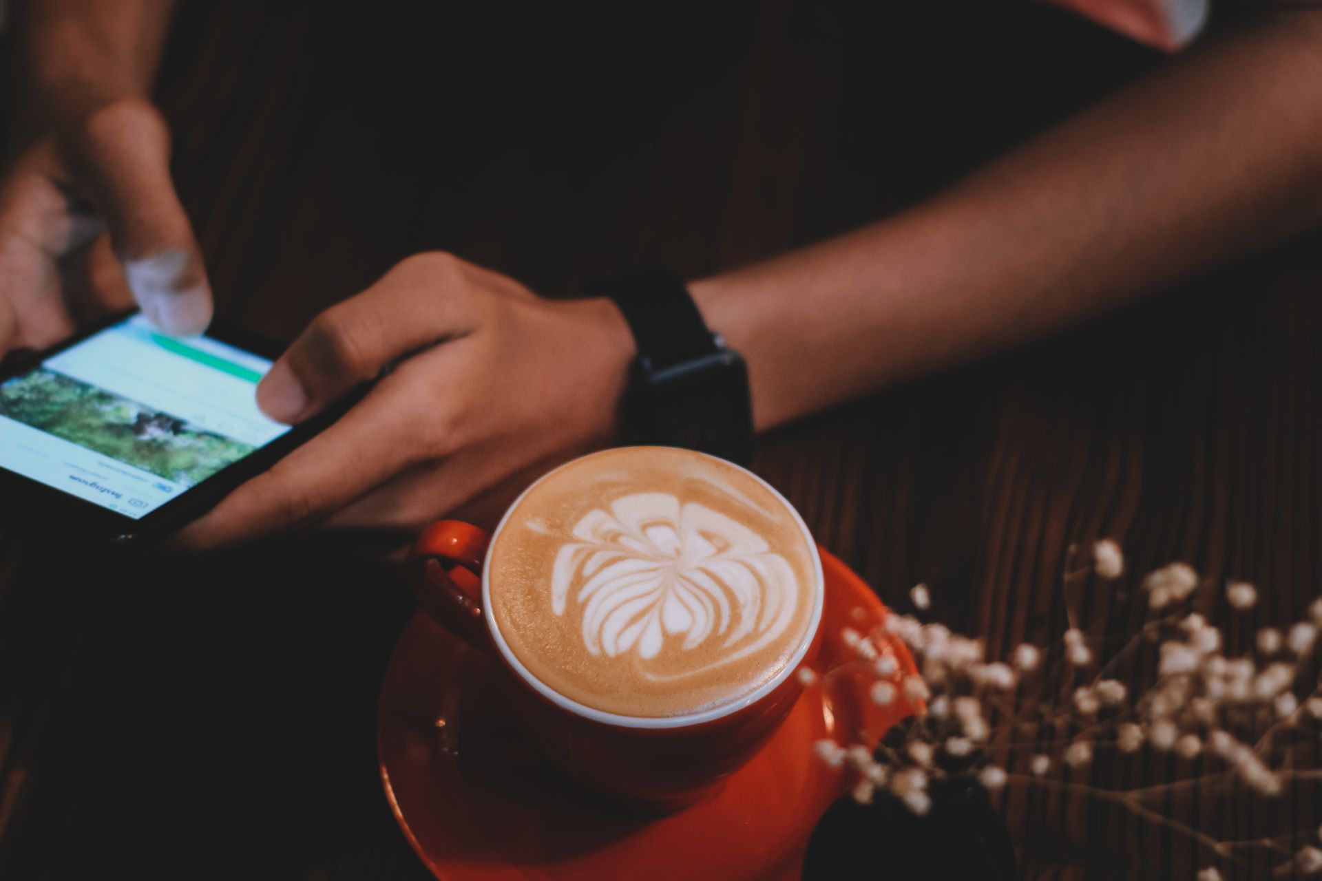 Customer scanning a QR code with their phone at a café table